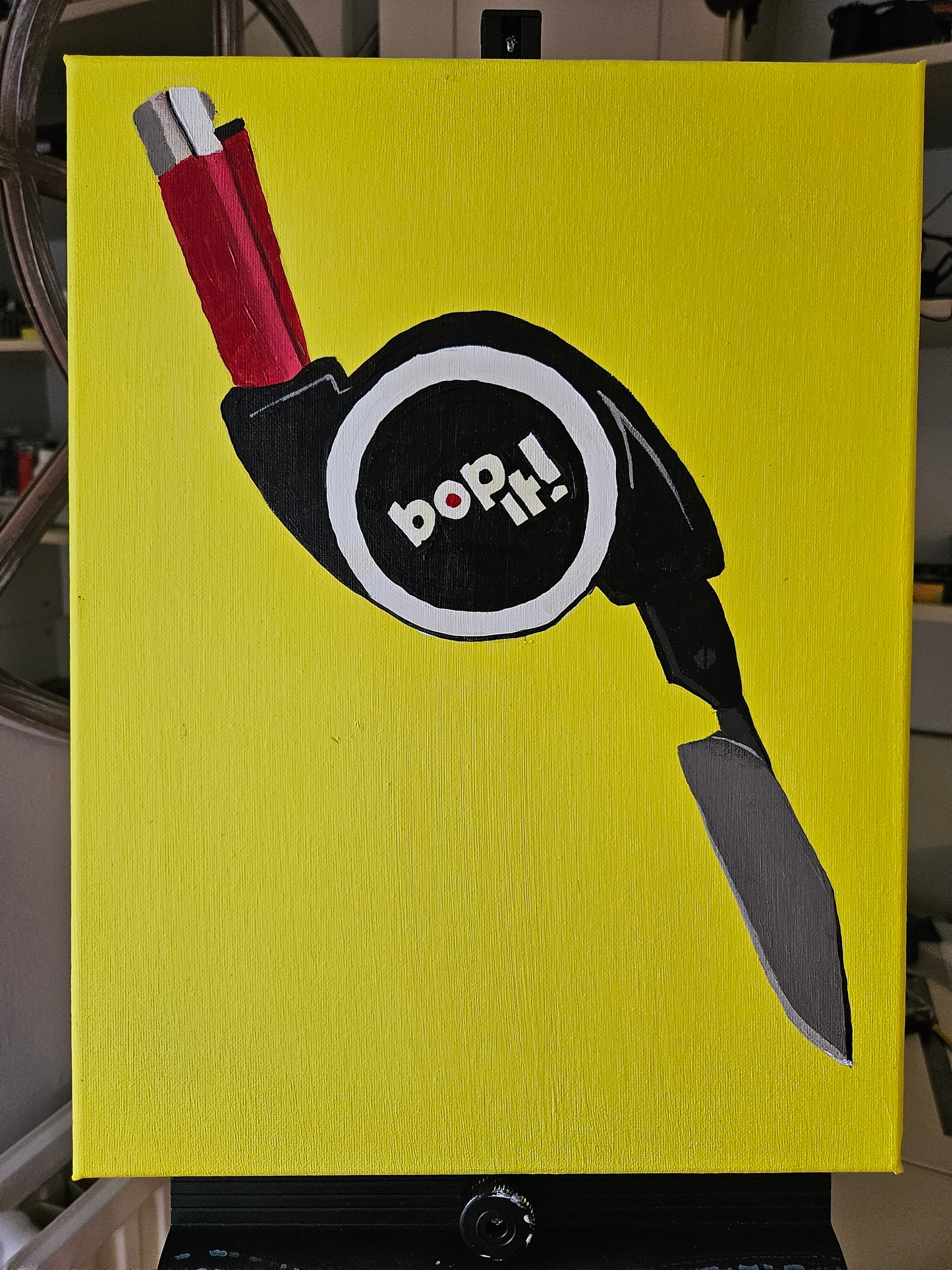 Satirical painting of a bop it with a lighter and knife. Acrylic on canvas. 
